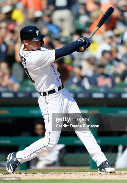 JaCoby Jones of the Detroit Tigers hits to center fielder Delino DeShields of the Texas Rangers, who misplays the ball that allows three runs to...