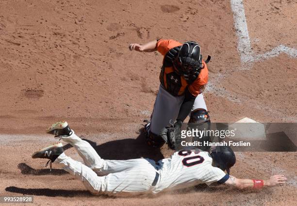 Chance Sisco of the Baltimore Orioles tags out Jake Cave of the Minnesota Twins at home plate during the sixth inning of the game on July 7, 2018 at...