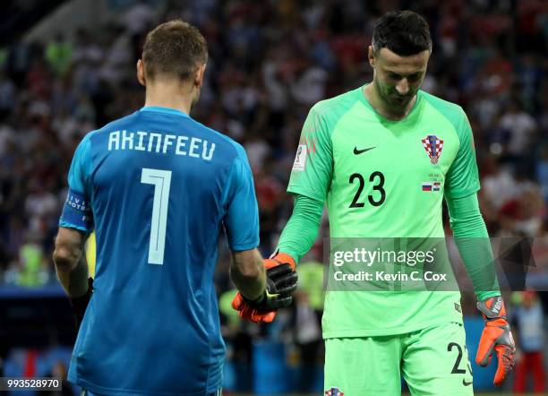 Igor Akinfeev of Russia greets Danijel Subasic of Croatia in the penalty shoot out during the 2018 FIFA World Cup Russia Quarter Final match between...