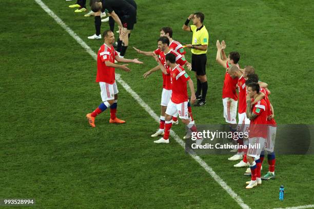 Sergey Ignashevich of Russia is congratulated by team mates after scoring his sides fourth penalty in the penalty shoot out during the 2018 FIFA...