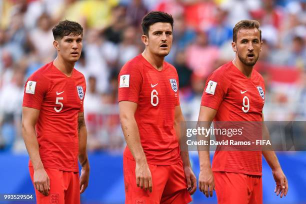 John Stones, Harry Maguire and Harry Kane of England look on during the 2018 FIFA World Cup Russia Quarter Final match between Sweden and England at...