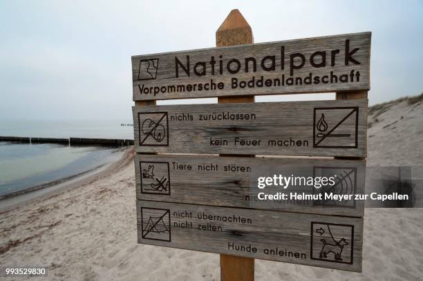 signs on the baltic sea beach, western pomerania lagoon area national park, zingst, darss, mecklenburg-western pomerania, germany - vorpommersche boddenlandschaft national park stockfoto's en -beelden