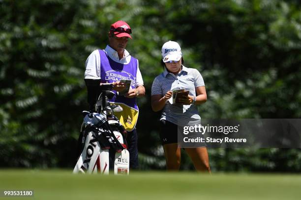Nasa Hataoka of Japan speaks with her caddie on the first hole during the third round of the Thornberry Creek LPGA Classic at Thornberry Creek at...