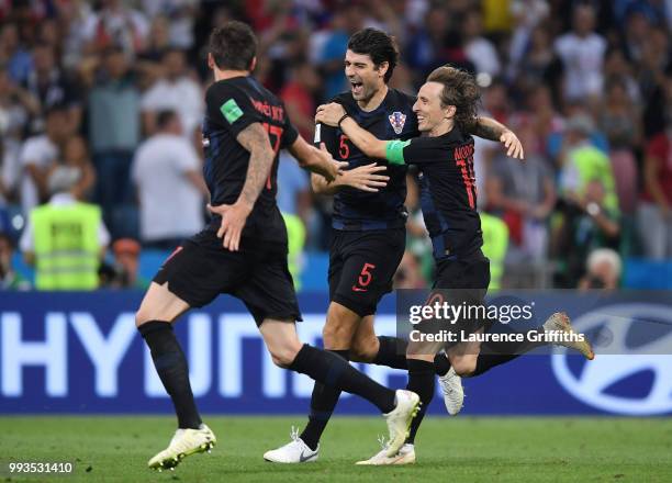 Vedran Corluka, Luka Modric and Mario Mandzukic of Croatia celebrate winning the penalty shoot out during the 2018 FIFA World Cup Russia Quarter...