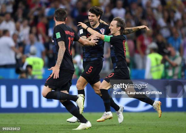 Vedran Corluka, Luka Modric and Mario Mandzukic of Croatia celebrate winning the penalty shoot out during the 2018 FIFA World Cup Russia Quarter...