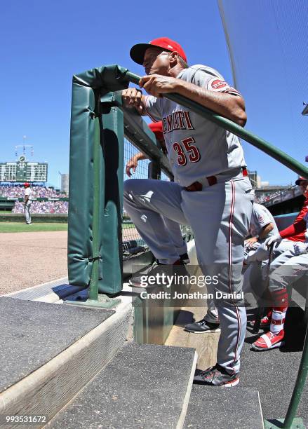 Manager Jim Riggleman of the Cincinnati Reds watches from the dugout as his team takes on the Chicago Cubs at Wrigley Field on July 6, 2018 in...