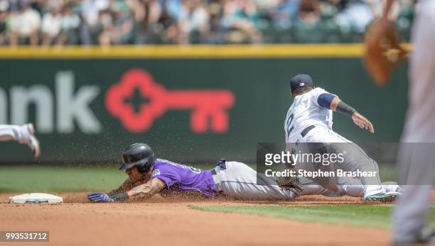 Ian Desmond of the Colorado Rockies slides safely to steal second base before shortstop Jean Segura of the Seattle Mariners can make a tag during the...