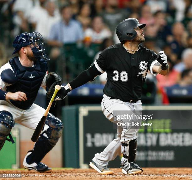 Omar Narvaez of the Chicago White Sox hits a double scoring three runs in the sixth inning as Max Stassi of the Houston Astros looks on at Minute...