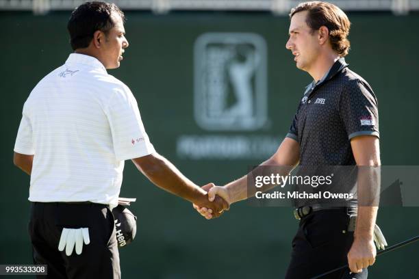Anirban Lahiri of India and Kelly Kraft shake hands after finishing their round on the 18th hole during round three of A Military Tribute At The...