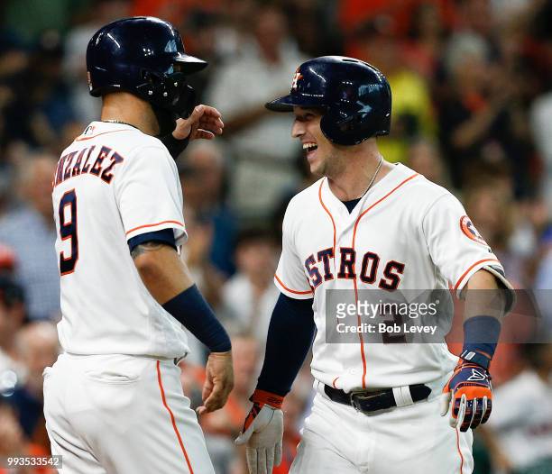 Alex Bregman of the Houston Astros receives congratulations from Marwin Gonzalez after he hit a home run against the Chicago White Sox at Minute Maid...