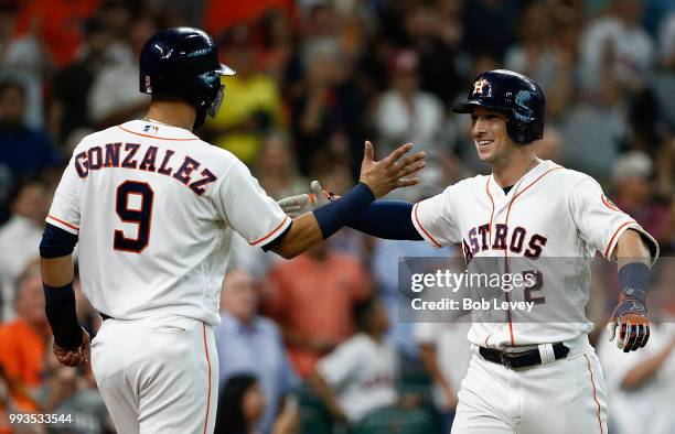 Alex Bregman of the Houston Astros receives congratulations from Marwin Gonzalez after he hit a home run against the Chicago White Sox at Minute Maid...
