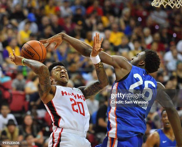 Mitchell Robinson of the New York Knicks blocks a shot from John Collins of the Atlanta Hawks during the 2018 NBA Summer League at the Thomas & Mack...