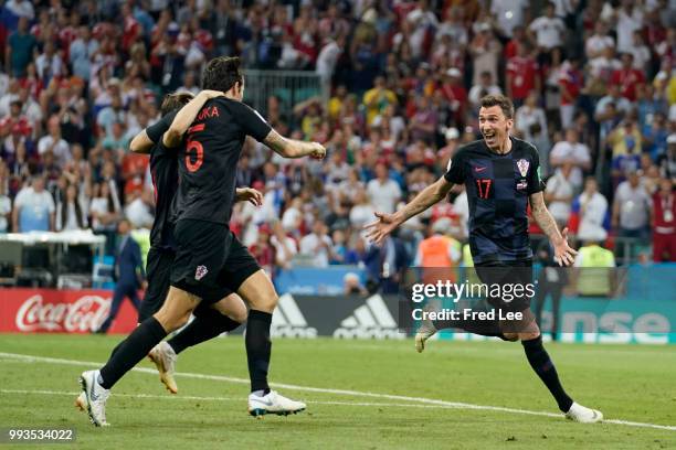 Vedran Corluka, Luka Modric and Mario Mandzukic of Croatia celebrate winning the penalty shoot out during the 2018 FIFA World Cup Russia Quarter...