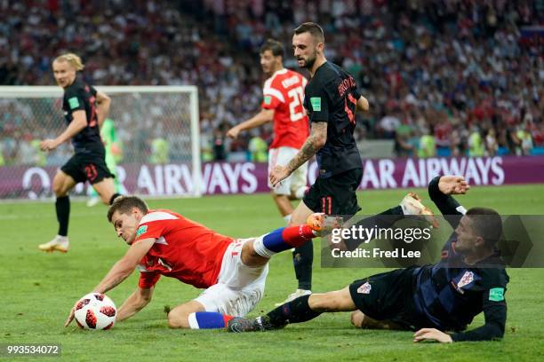Mateo Kovacic of Croatia tackles Roman Zobnin of Russia during the 2018 FIFA World Cup Russia Quarter Final match between Russia and Croatia at Fisht...