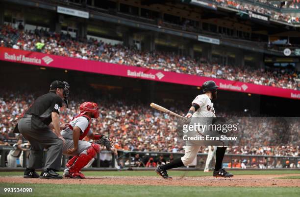 Brandon Belt of the San Francisco Giants hits a single that scored a run in the eighth inning against the St. Louis Cardinals at AT&T Park on July 7,...