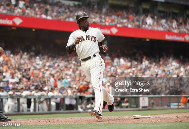 Alen Hanson of the San Francisco Giants runs home to score on a hit by Brandon Belt in the eighth inning against the St. Louis Cardinals at AT&T Park...