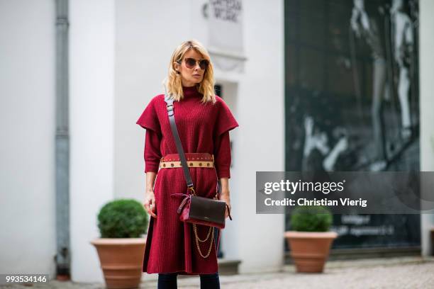 Gitta Banko wearing a burgundy cashmere long sleeve and burgundy oversize cashmere short sleeve sweater by Agnona, dark-blue jeans by Citizens of...