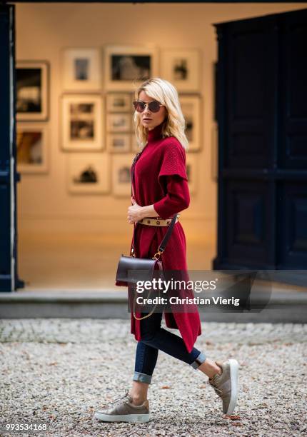 Gitta Banko wearing a burgundy cashmere long sleeve and burgundy oversize cashmere short sleeve sweater by Agnona, dark-blue jeans by Citizens of...