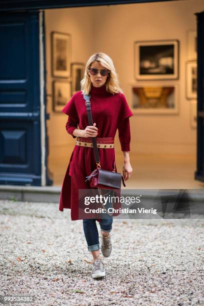 Gitta Banko wearing a burgundy cashmere long sleeve and burgundy oversize cashmere short sleeve sweater by Agnona, dark-blue jeans by Citizens of...