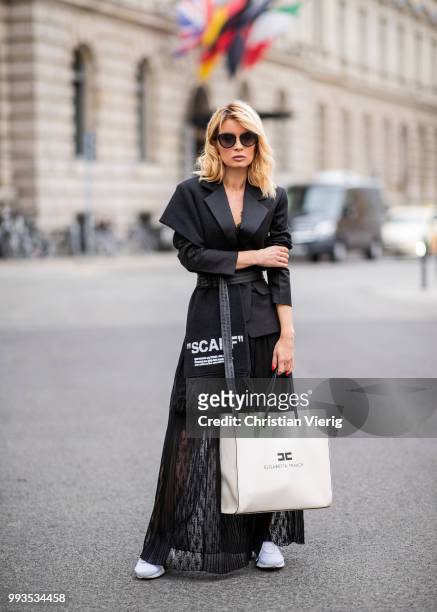 Gitta Banko wearing black lace bra by Anine Bing, black lace skirt by Jadicted, black blazer by Helmut Lang, black statement scarf and grey-black...
