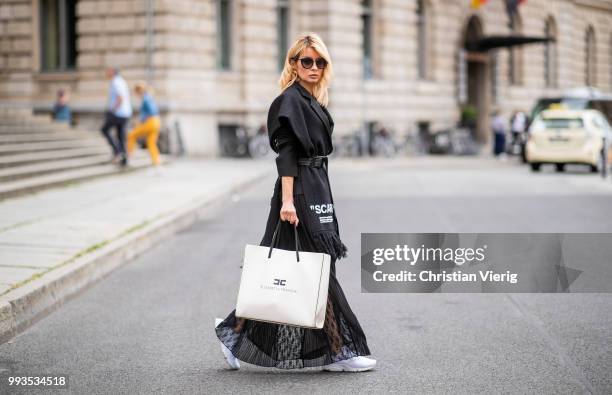 Gitta Banko wearing black lace bra by Anine Bing, black lace skirt by Jadicted, black blazer by Helmut Lang, black statement scarf and grey-black...