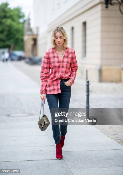 Lisa Hahnbueck wearing plaid Burberry button shirt, dark blue denim jeans Levis Re/done, Jimmy Choo bag, Gianvito Rossi ankle boots during the Berlin...