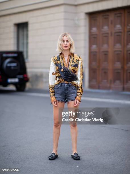 Lisa Hahnbueck wearing silk blouse with print Versace, Versace fanny belt bag , Levis 501 shorts, Tods loafer during the Berlin Fashion Week July...
