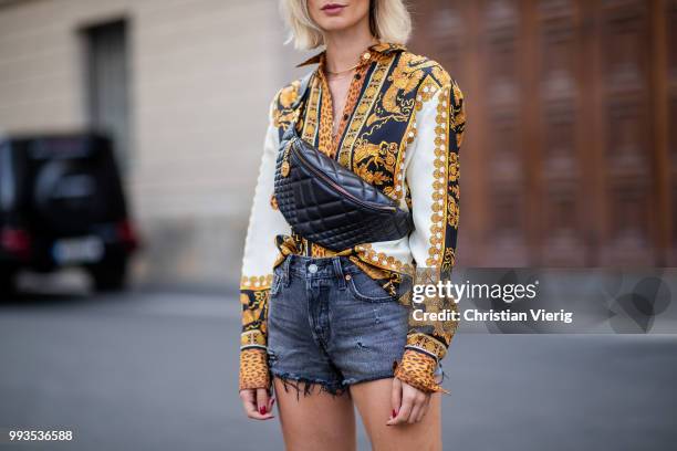 Lisa Hahnbueck wearing silk blouse with print Versace, Versace fanny belt bag , Levis 501 shorts, Tods loafer during the Berlin Fashion Week July...