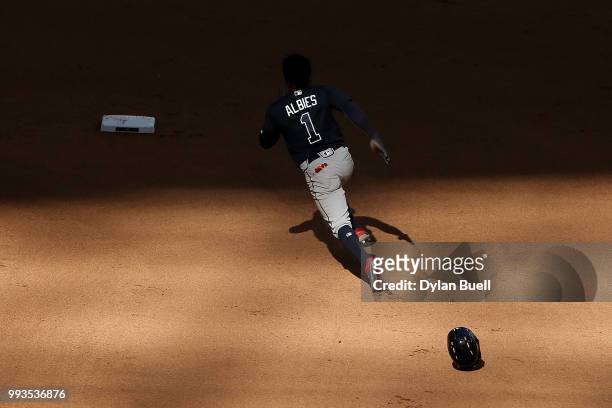 Ozzie Albies of the Atlanta Braves runs to second base in the eighth inning against the Milwaukee Brewers at Miller Park on July 7, 2018 in...