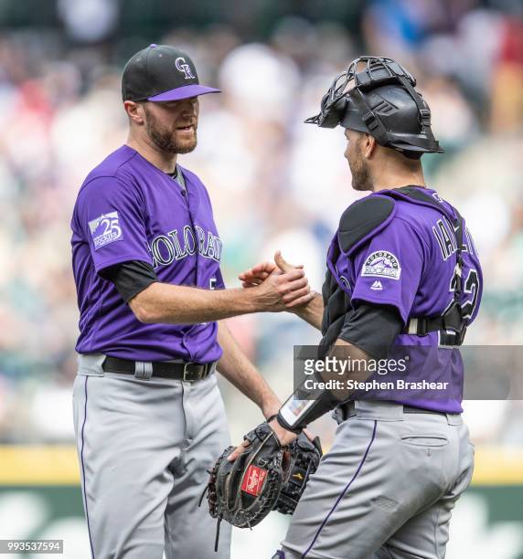 Relief pitcher Wade Davis of the Colorado Rockies and catcher Chris Iannetta of the Colorado Rockies celebrate after a game against the Seattle...