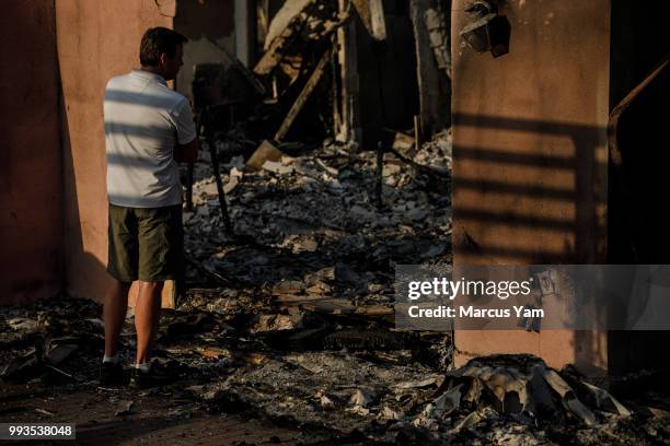 Eric Durtschi takes in the reality of his home destroyed by wildfire, in Goleta, Calif., on July 7, 2018.