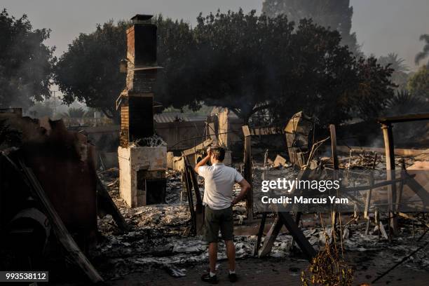 Eric Durtschi takes in the reality of his home destroyed by wildfire, in Goleta, Calif., on July 7, 2018.