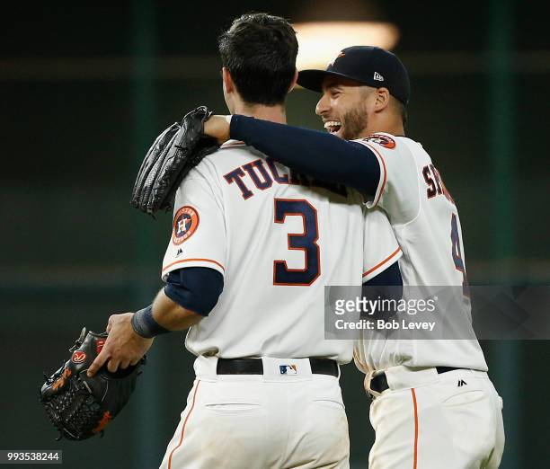 George Springer of the Houston Astros shares a moment with Kyle Tucker as they take the field for the ninth inning against the Chicago White Sox at...