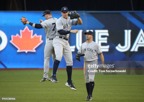 Aaron Judge of the New York Yankees celebrates their victory with Clint Frazier and Brett Gardner during MLB game action against the Toronto Blue...