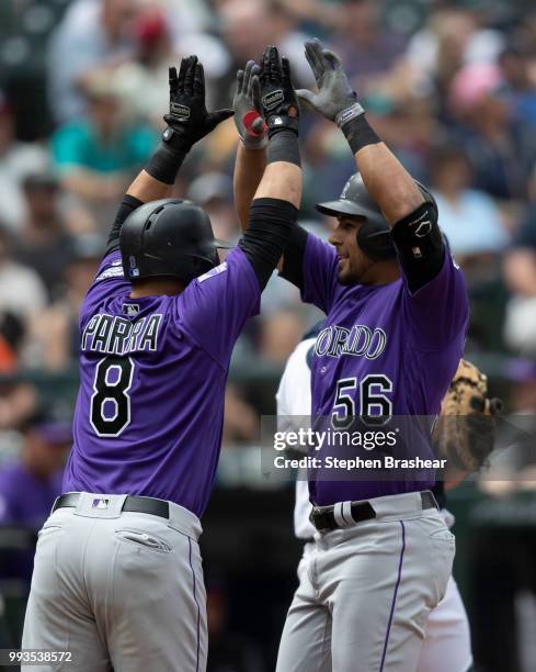 Noel Cuevas of the Colorado Rockies is congratulated after hitting a three-run home run off of starting pitcher James Paxton of the Seattle Mariners...