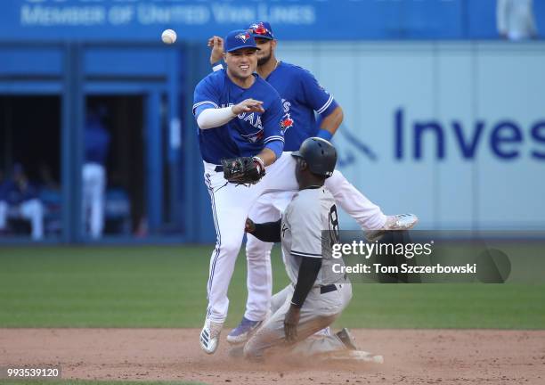 Aledmys Diaz of the Toronto Blue Jays collides with Didi Gregorius of the New York Yankees as Gregorius arrives at second base safely but Diaz throws...