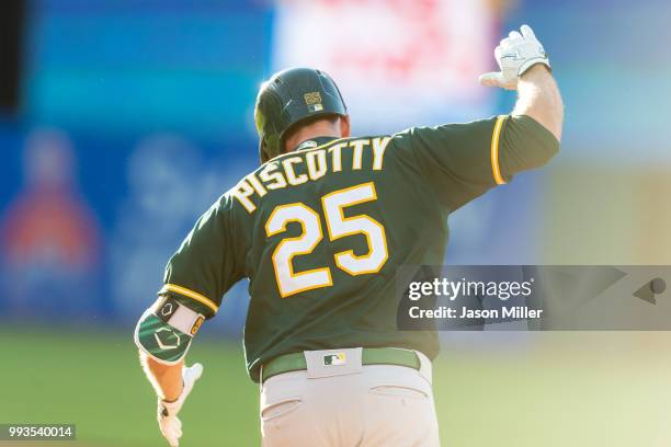 Stephen Piscotty of the Oakland Athletics celebrates as he rounds the base after hitting a two run home run during the eleventh inning against the...