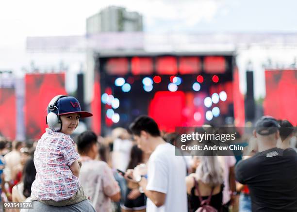 Child enjoys the music on top of his mom's shoulders while watching Bazzi's performance on stage during Day 2 of FVDED In The Park at Holland Park on...
