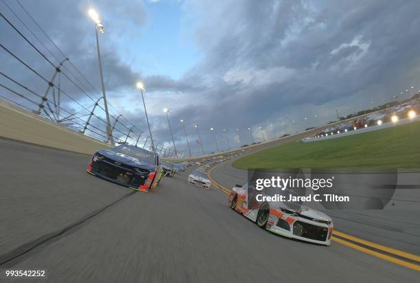 Chase Elliott, driver of the Hooters Chevrolet, and Alex Bowman, driver of the Axalta Chevrolet race the pace lap prior to the start of the Monster...