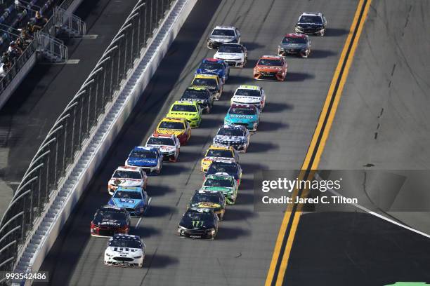 Brad Keselowski, driver of the Stars Stripes and Lites Ford, leads a pack of cars during the Monster Energy NASCAR Cup Series Coke Zero Sugar 400 at...