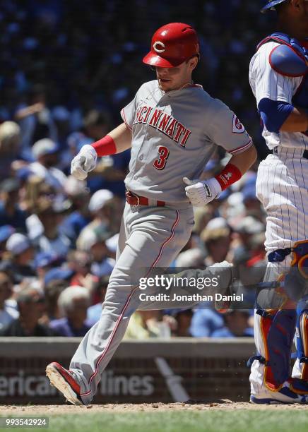 Scooter Gennett of the Cincinnati Reds scores a run against the Chicago Cubs at Wrigley Field on July 6, 2018 in Chicago, Illinois. The Reds defeated...