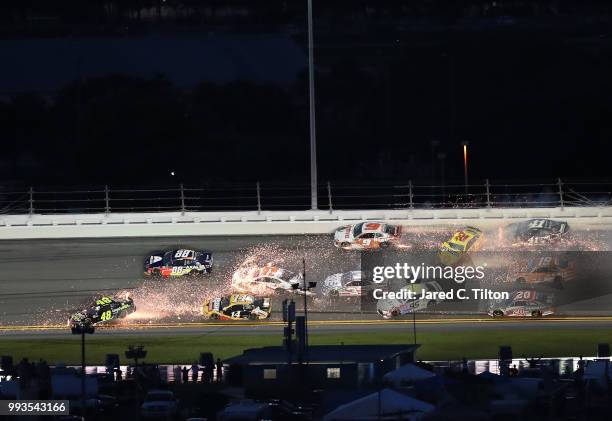 Chase Elliott, driver of the Hooters Chevrolet, and Denny Hamlin, driver of the FexEx Cares Toyota, are involved in an on-track incident with several...
