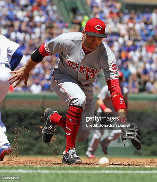 Joey Votto of the Cincinnati Reds dives for a ball that turned out to be foul against the Chicago Cubs at Wrigley Field on July 6, 2018 in Chicago,...