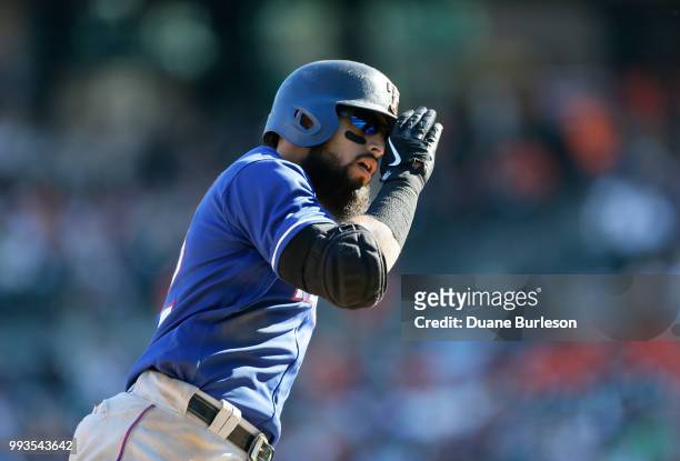 Rougned Odor of the Texas Rangers salutes as he rounds third base after hitting a solo home run against the Detroit Tigers during the sixth inning at...