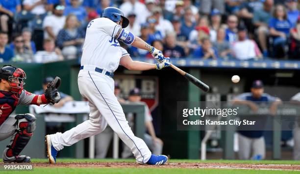 The Kansas City Royals' Mike Moustakas connects on an RBI single to score Whit Merrifield in the third inning against the Boston Red Sox at Kauffman...