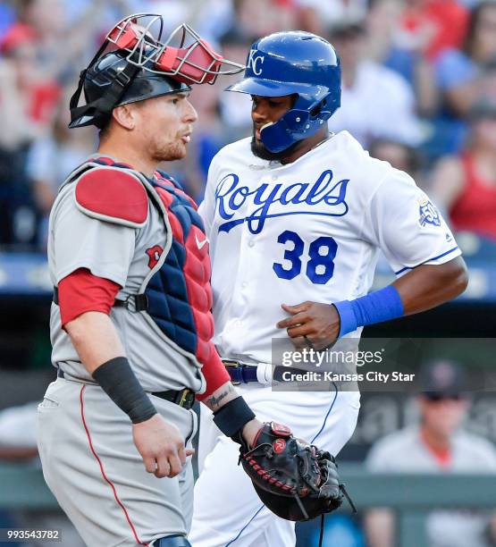 The Kansas City Royals' Jorge Bonifacio scores behind Boston Red Sox catcher Christian Vazquez on a sacrifice fly by Salvador Perez in the third...