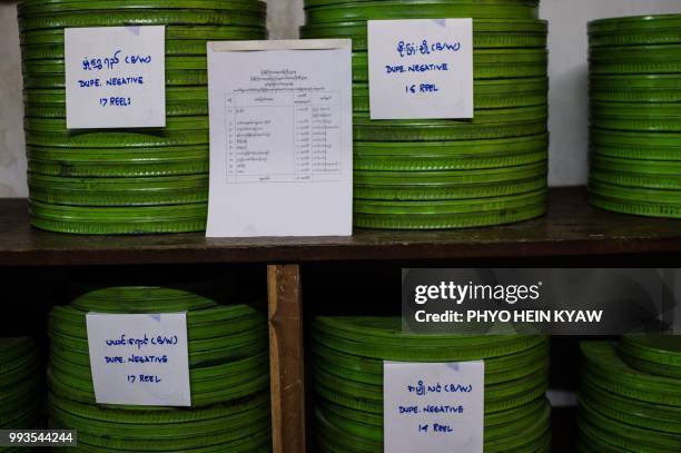 This picture taken on May 15, 2018 shows cases of old negative films stored at the state archive building in Yangon. - The restoration of a 1934...