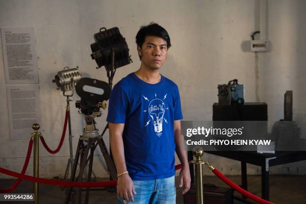 This picture taken on April 12, 2018 shows contemporary Myanmar filmmaker Maung Okkar founder of the Save the Myanmar Film poses before vintage...