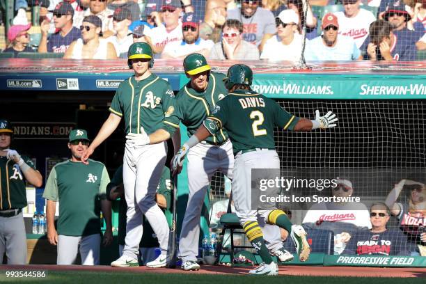 Oakland Athletics designated hitter Khris Davis is congratulated by Oakland Athletics outfielder Stephen Piscotty after hitting a home run to tie the...