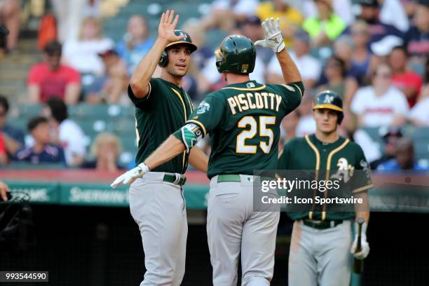 Oakland Athletics outfielder Stephen Piscotty gets a high-five from Oakland Athletics first baseman Matt Olson after hitting a 2-run home run during...